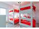Fun bedroom featuring two sets of bunkbeds with bright red bedding and access to the screened outdoor patio at 109 Kenny Blvd, Haines City, FL 33844