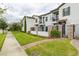 Well-maintained townhouses with gated entrances, lush landscaping, and tidy sidewalks create curb appeal at 109 Kenny Blvd, Haines City, FL 33844