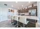 Modern kitchen island with white quartz countertop and four chairs and stainless steel refrigerator at 109 Kenny Blvd, Haines City, FL 33844