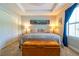 Relaxing main bedroom featuring a decorative headboard, matching lamps, and a scenic view from the window at 109 Kenny Blvd, Haines City, FL 33844