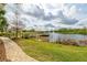 Scenic pond view with fountain and dock offers a tranquil escape amidst lush landscaping and serene surroundings at 109 Kenny Blvd, Haines City, FL 33844