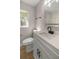 Updated bathroom featuring a modern vanity, black hardware, and a shower with white marble style tiles at 11572 Se 60Th Ave, Belleview, FL 34420