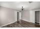 Bedroom featuring a modern ceiling fan, spacious closet, and updated flooring at 11572 Se 60Th Ave, Belleview, FL 34420