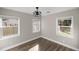 Inviting bedroom with multiple windows, stylish fan, and modern flooring for a cozy retreat at 11572 Se 60Th Ave, Belleview, FL 34420