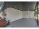 Covered carport area featuring ample space, lighting, and a connection to the main house at 11572 Se 60Th Ave, Belleview, FL 34420
