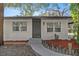 Charming single story home with neutral-toned exterior, updated windows, and mature landscaping at 11572 Se 60Th Ave, Belleview, FL 34420