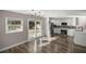 Bright kitchen with stainless steel appliances, white cabinetry, and sliding doors to the backyard at 11572 Se 60Th Ave, Belleview, FL 34420