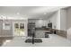 Modern kitchen with quartz countertops, stainless steel refrigerator, and stylish backsplash at 11572 Se 60Th Ave, Belleview, FL 34420
