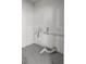 A utilitarian room with connections for a washer and dryer on a painted concrete floor at 11572 Se 60Th Ave, Belleview, FL 34420