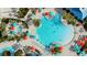 Aerial view of the community pool area with lounge chairs, colorful umbrellas and a luxurious hot tub at 1221 Aloha Blvd, Davenport, FL 33897