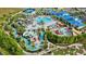 Extensive aerial view of a resort-style waterpark, complete with slides, pools, and a miniature golf area at 1221 Aloha Blvd, Davenport, FL 33897