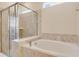 Spacious bathroom featuring a shower and soaking tub at 1221 Aloha Blvd, Davenport, FL 33897