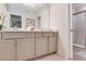 Well-lit bathroom with double sink vanity and a glass-enclosed shower at 1221 Aloha Blvd, Davenport, FL 33897