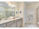Elegant bathroom with double vanity and a glass-enclosed shower at 1221 Aloha Blvd, Davenport, FL 33897