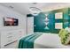 Modern bedroom with ambient lighting, wall art, and a flat-screen television at 1221 Aloha Blvd, Davenport, FL 33897