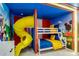 Playful ' bedroom with a bunk bed, slide, and vibrant cartoon decor at 1221 Aloha Blvd, Davenport, FL 33897