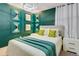 Charming bedroom with green walls, accent lighting, and a cozy atmosphere at 1221 Aloha Blvd, Davenport, FL 33897