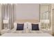 Relaxing bedroom with matching nightstands, lamps, and a bright accent wall at 1221 Aloha Blvd, Davenport, FL 33897