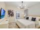 Comfortable bedroom with a modern chandelier and an ensuite bathroom at 1221 Aloha Blvd, Davenport, FL 33897