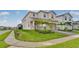 Landscaped home featuring a well-manicured lawn and inviting curb appeal in a sidewalk community at 1221 Aloha Blvd, Davenport, FL 33897