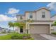 Charming two-story home featuring a two-car garage, well-manicured lawn, and inviting curb appeal at 1221 Aloha Blvd, Davenport, FL 33897