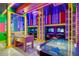 Vibrant game room featuring foosball, air hockey, and neon lighting for an entertaining atmosphere at 1221 Aloha Blvd, Davenport, FL 33897