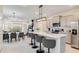 Stylish kitchen with stainless steel appliances, a large island, and an open view to the living and dining areas at 1221 Aloha Blvd, Davenport, FL 33897