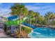 Large community waterslides emptying into a pool area surrounded by palm trees and landscaping at 1221 Aloha Blvd, Davenport, FL 33897