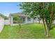 Backyard showcasing a well-maintained lawn, with a view of the home's screened-in patio at 12691 Calderdale Ave, Windermere, FL 34786