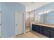 Bathroom with a double vanity, granite countertops, and a tiled glass shower at 12691 Calderdale Ave, Windermere, FL 34786