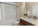 Bathroom with granite countertop, white tile shower over tub, and dark wood vanity at 12691 Calderdale Ave, Windermere, FL 34786