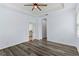 Spacious bedroom featuring a tray ceiling, wood-look floors, and neutral paint at 12691 Calderdale Ave, Windermere, FL 34786