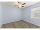 Bedroom features neutral carpet, light blue walls, a ceiling fan, and a window with blinds at 12691 Calderdale Ave, Windermere, FL 34786