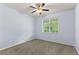 Bedroom features neutral carpet, light blue walls, a ceiling fan, and a window with green views at 12691 Calderdale Ave, Windermere, FL 34786