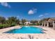 Another view of the community pool with ample seating and well-maintained landscaping at 12691 Calderdale Ave, Windermere, FL 34786