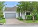 Charming single-Gathering home featuring a two-car garage, lush landscaping, and inviting curb appeal at 12691 Calderdale Ave, Windermere, FL 34786