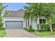 Charming single-Gathering home with gray exterior, attached garage, and landscaped front yard at 12691 Calderdale Ave, Windermere, FL 34786