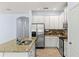 Open kitchen boasts granite countertops, stainless steel appliances, and ample cabinet space at 12691 Calderdale Ave, Windermere, FL 34786