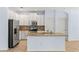 Well-lit kitchen featuring an island, stainless steel appliances, and white cabinetry at 12691 Calderdale Ave, Windermere, FL 34786