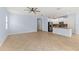 Open floor plan living space with kitchen, tile floors, and plenty of natural light at 12691 Calderdale Ave, Windermere, FL 34786