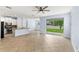Open concept living space featuring tile floors, kitchen island, and sliding glass doors to backyard at 12691 Calderdale Ave, Windermere, FL 34786