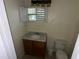 This bathroom features a vanity and window, with tiled floors, a toilet, and a window for natural light at 1420 Bethesda St, Apopka, FL 32703