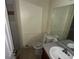 This bathroom includes a toilet, mirror, and sink vanity, awaiting renovation and personalization at 1420 Bethesda St, Apopka, FL 32703