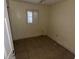 A cozy bedroom with tiled flooring, a window with blinds, and neutral walls, awaiting your personal touch at 1420 Bethesda St, Apopka, FL 32703