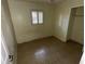 A cozy bedroom with tiled flooring, a window with blinds, and neutral walls, awaiting your personal touch at 1420 Bethesda St, Apopka, FL 32703