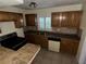 Well-lit kitchen with wooden cabinets, tile backsplash, and tile flooring at 1420 Bethesda St, Apopka, FL 32703