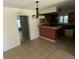 Kitchen with breakfast bar, wooden cabinets, and tile flooring at 1420 Bethesda St, Apopka, FL 32703