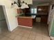 Kitchen featuring wooden cabinets, breakfast bar, and tile flooring at 1420 Bethesda St, Apopka, FL 32703