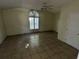 The living room features a large window and tiled floors, providing great light and an easy to clean surface at 1420 Bethesda St, Apopka, FL 32703