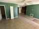 Open-concept living space featuring tile floors and a view into the kitchen at 1420 Bethesda St, Apopka, FL 32703